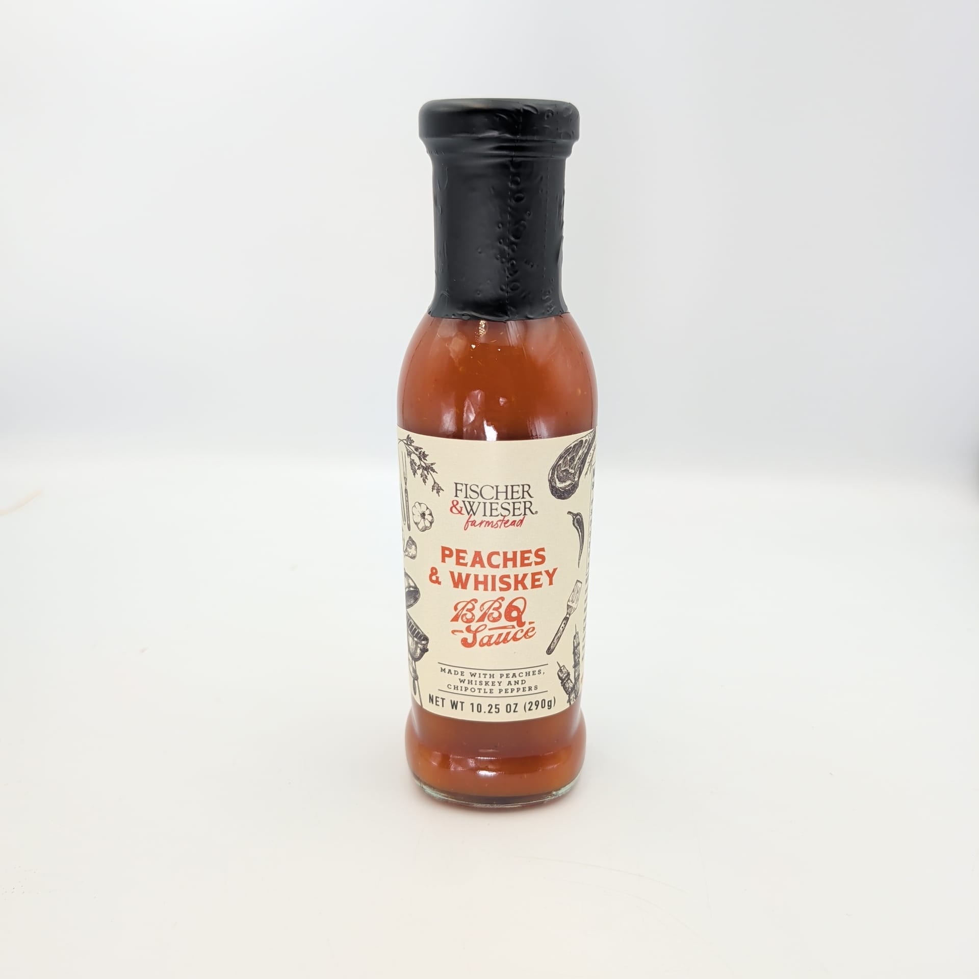 Bottle of Fischer & Wieser Peaches & Whiskey BBQ Sauce on a white background, featuring a sweet and smoky Texas-inspired flavor for grilling and gourmet gift baskets