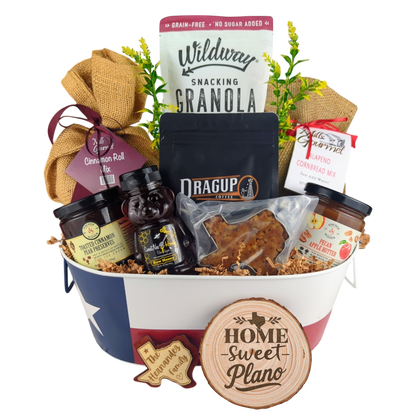 Plano Texas Breakfast Basket on a white background, showcasing pecan coffee, granola, cinnamon rolls, jalapeño cornbread mix, pecan apple butter, raw honey, and praline.