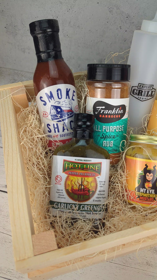a create filled with texas bbq goods including bbq sauce, hot sauce, hot mustard, and seasoning