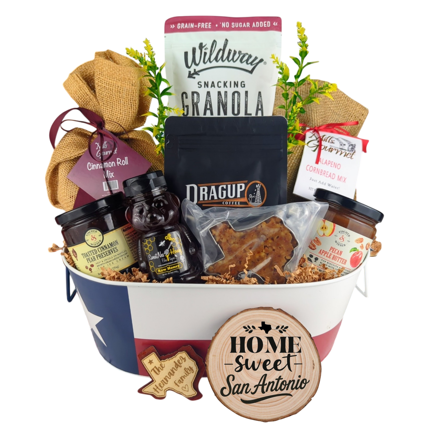 San Antonio Family Breakfast Basket on a white background, showcasing pecan coffee, granola, cinnamon rolls, jalapeño cornbread mix, pecan apple butter, raw honey, and praline.