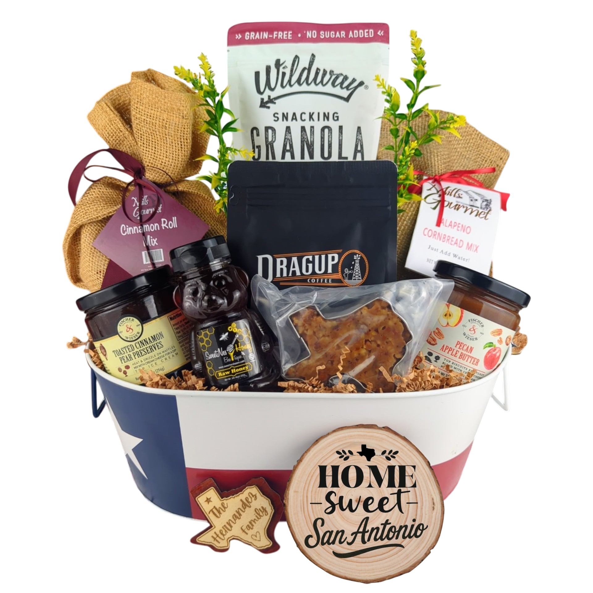 San Antonio Family Breakfast Basket on a white background, showcasing pecan coffee, granola, cinnamon rolls, jalapeño cornbread mix, pecan apple butter, raw honey, and praline.