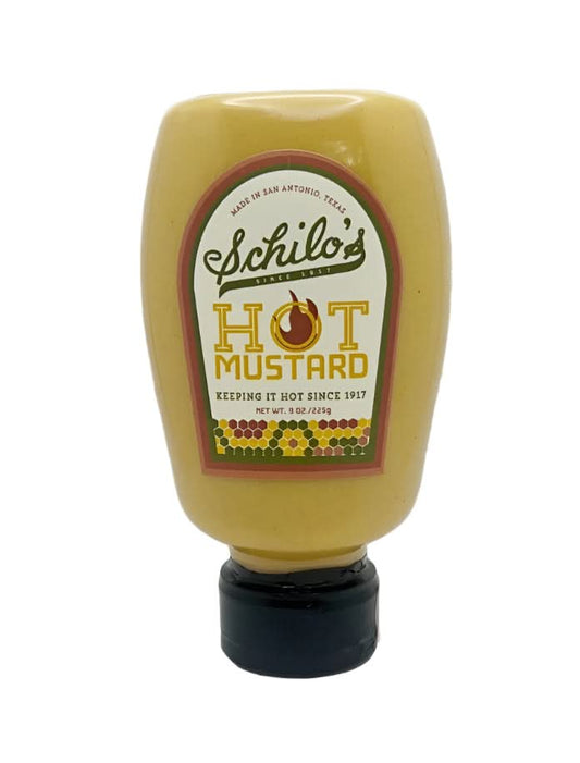 Schilo’s Hot Mustard in a classic jar, highlighting its bold, tangy flavor, displayed on a wooden table as part of a Texas gift collection.