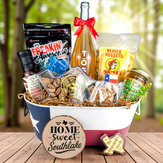 Southlake Texas Family Home Toast & Treats basket with TÖST ROSÉ, Peach Pepper Jelly, Buc-ee’s Beaver Nuggets, Texas pecans, praline, chipotle sauce, and Texas flag tin