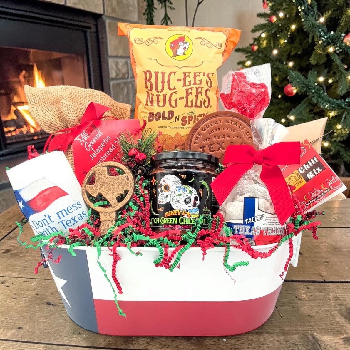 Texas Christmas Comforts gift in a small Texas flag tin, straight-facing view with Christmas ribbon and nine included products