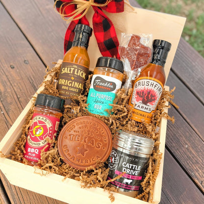 Angled view of Texas Pitmaster Pantry showing seven barbecue favorites and keepsakes arranged in a wooden gift box.