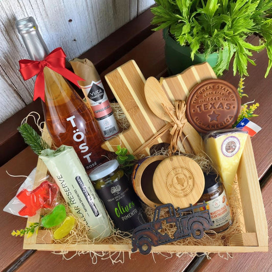 a texas-themed charcuterie and gourmet foods gift crate filled with cheese, olvies, crackers, sausage, preserves, and more
