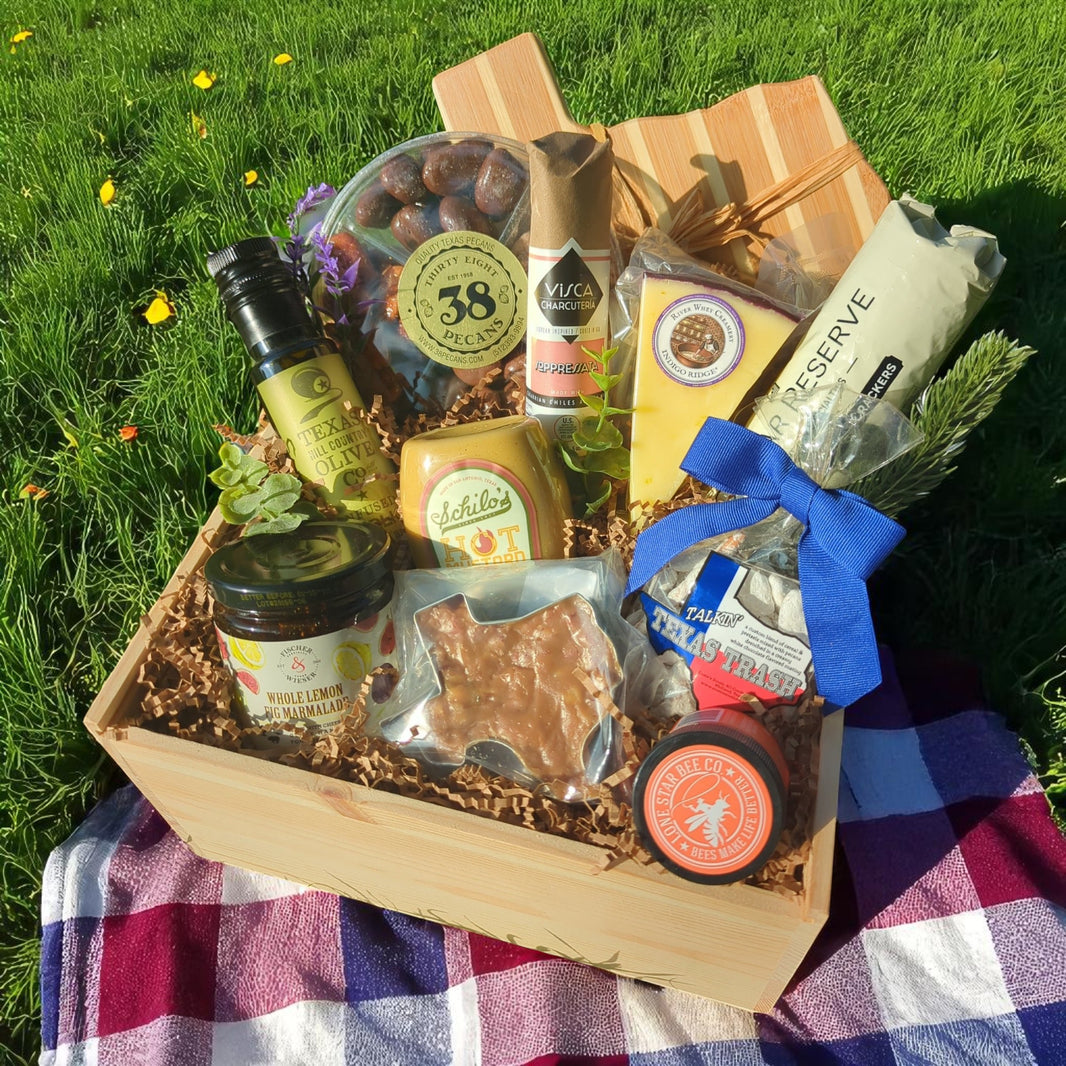 a Texas Rancher-themed wood gift box filled with Texas-sourced specialty foods icluding artisan cheese, candied pecans, praline, honey, and preserves