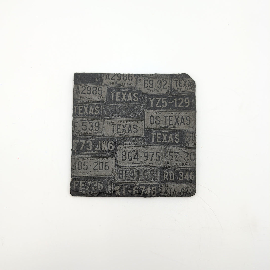 a square slate coaster with texas license plates collage