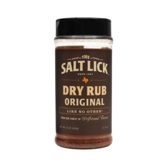Bottle of The Salt Lick Original Dry Rub seasoning with a black lid and dark brown label, featuring vintage-style typography and Texas branding, filled with reddish-brown spice blend on a white background