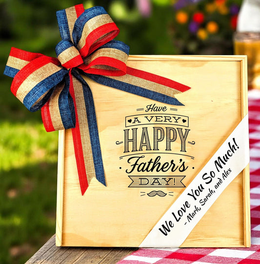 Wooden father's day gift box with a red, white, and blue ribbon on a checkered tablecloth.