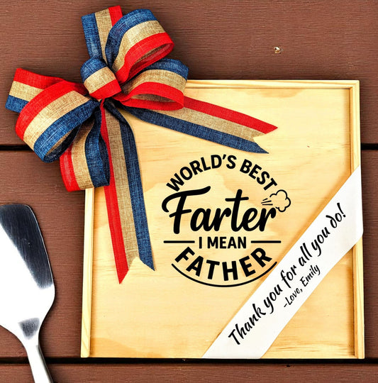 a wood gift box with "world's best farter I mean Father" engraved on the lid, with red white and blue striped bow and custom printed ribbon 
